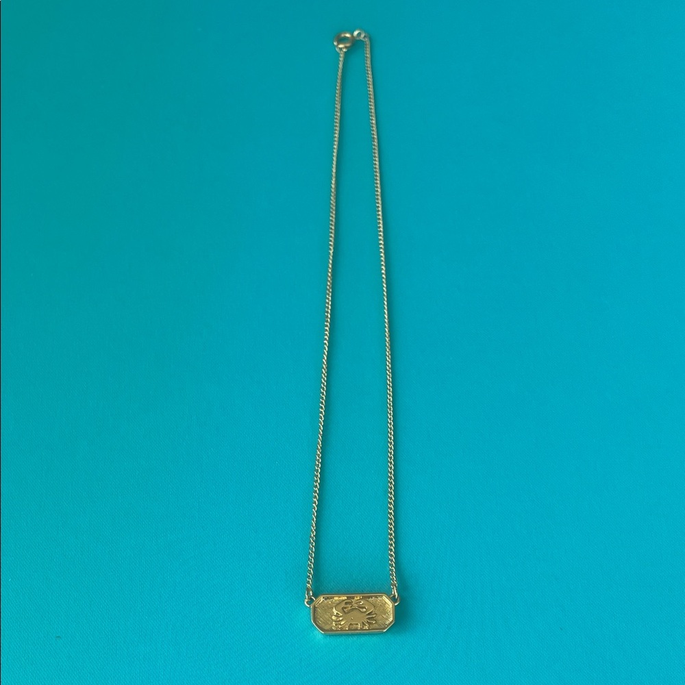 Trifari gold-tone Cancer zodiac pendant.  Approximately 14.5” total length.